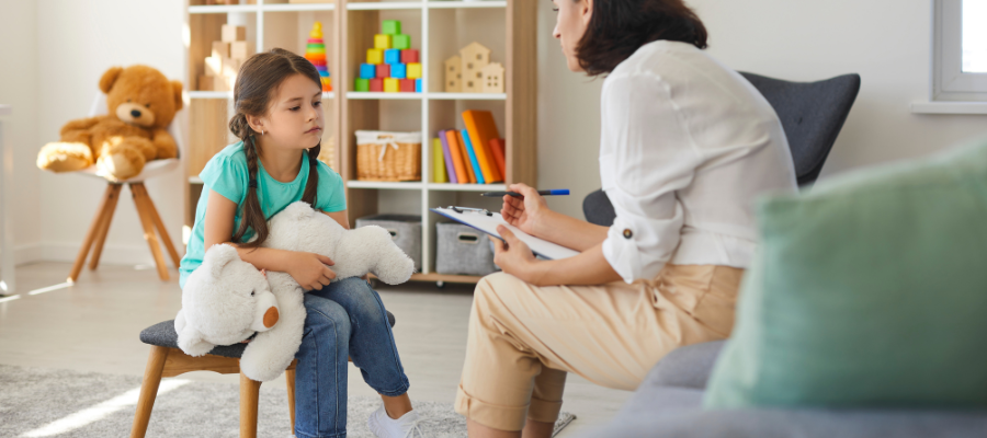 Autism Tests and Screeners: Understanding the Most Common Autism Testing Tools 1 clinician giving an autism spectrum test